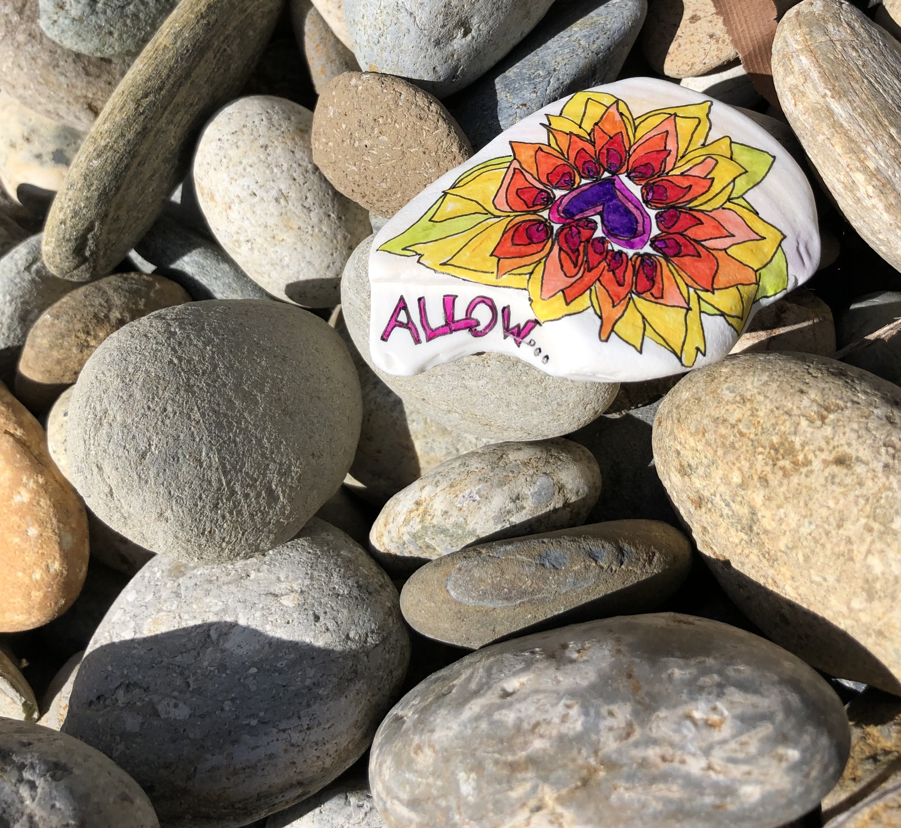 Painted stone saying Allow
